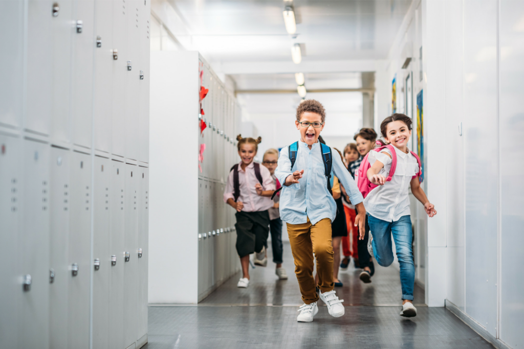 Happy Children running down a school hallway