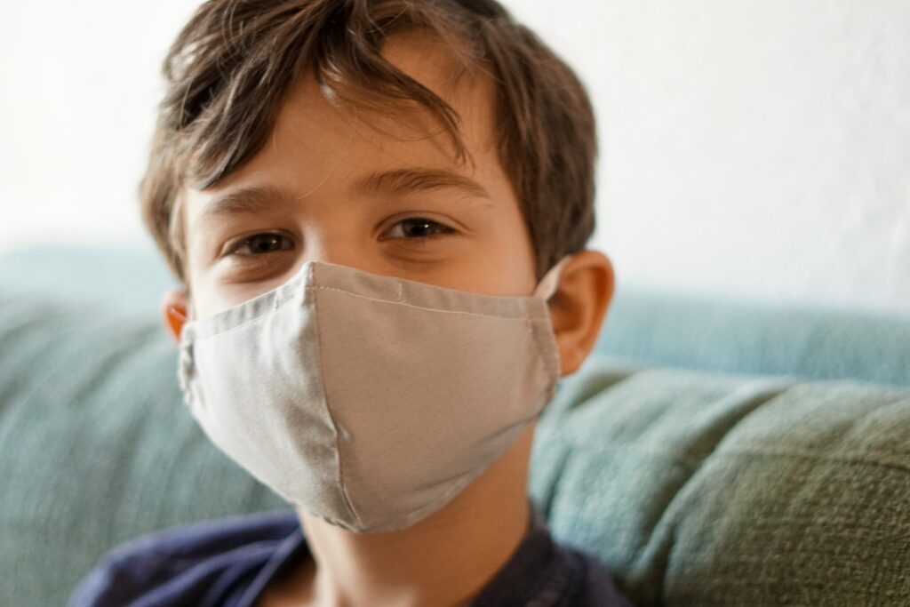 child wearing face mask, in need of medical attention