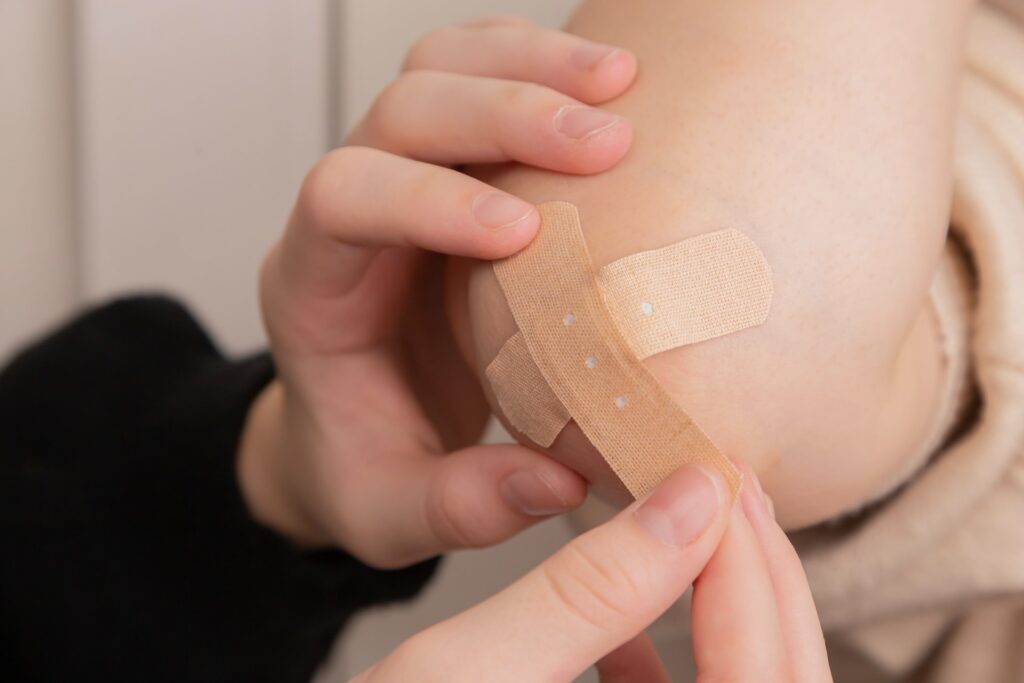 putting bandaid on wound, open wounds